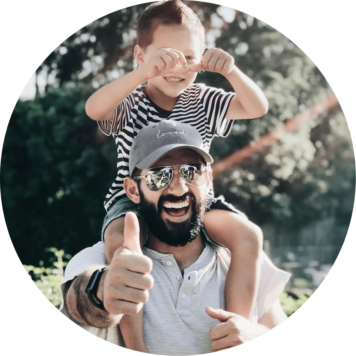A man holding a little boy on his shoulders.